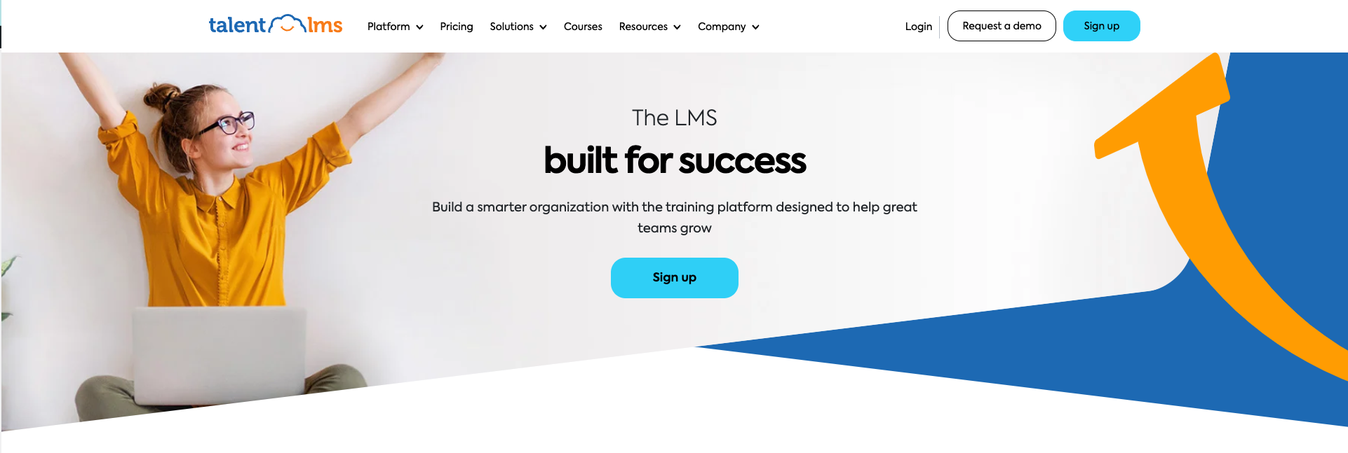 TalentLMS hero image of woman in yellow shirt with her arms up. Title: The LMS built for success. 